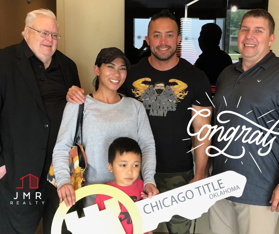 edmond buyers agent Jimmy Hughes standing with a family he recently helped finalize a real estate deal