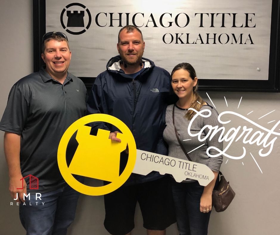 oklahoma real estate agent Jimmy Hughes standing with a recent client