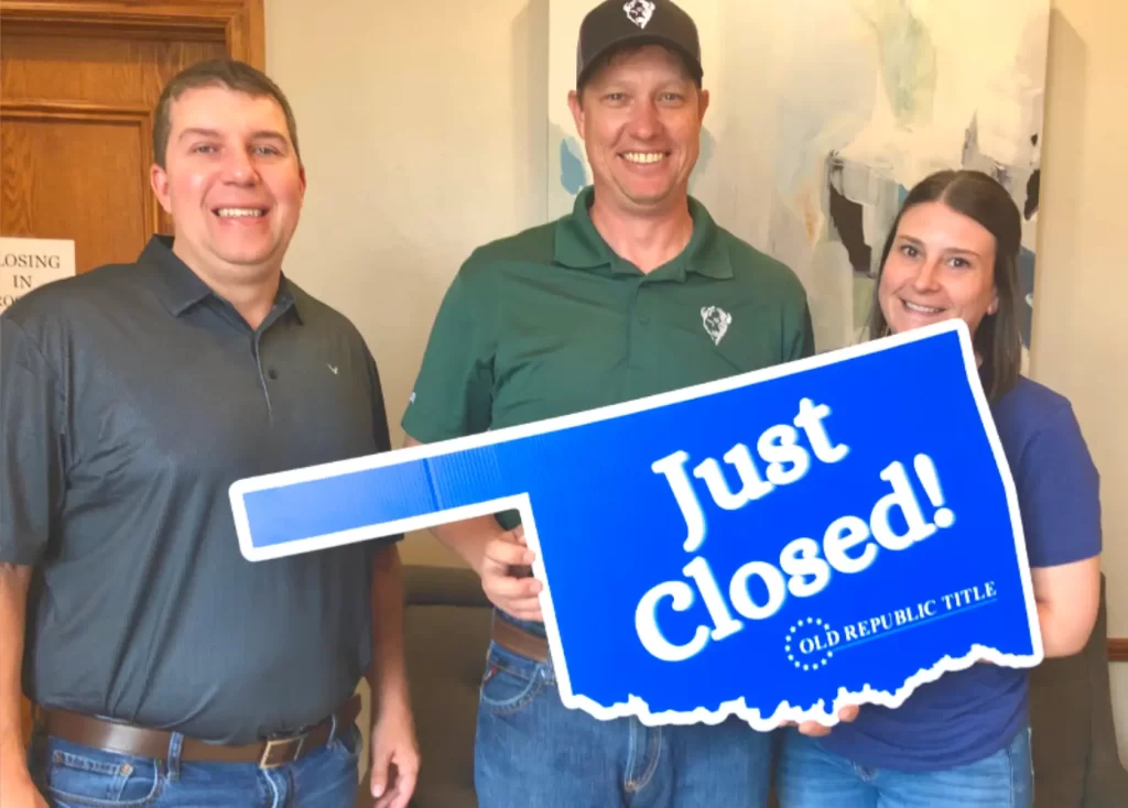 Jimmy Hughes real estate closing with buyers in Mustang, Oklahoma